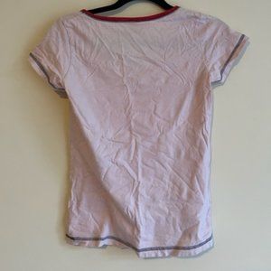 baby pink top with a dog figure on it